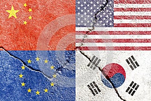 Closeup of USA, China, EU, and South Korea flags on weathered and cracked wall background