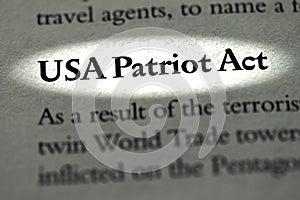 Closeup of The USA Patriot Act printed and highlighted in textbook on white page.