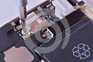 Closeup with used smartphone repair with screwdriver