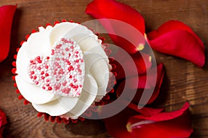 Closeup of Valentine`s Day Cupcake and Rose Petals