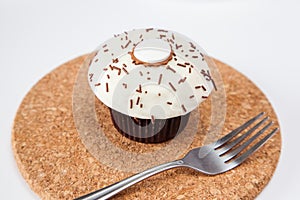 Closeup vanilla cream cupcake with chocolate sprinkle