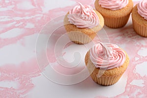 Closeup vanilla cupcake with pink frosting