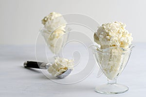 closeup vanilla ice cream scoops with metal scoop