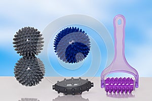 Closeup of various therapy and fitness equipment, such as massage balls or hedgehog balls and roller for health therapie on table