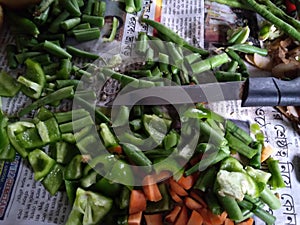 A closeup with vegetables cutting with the help of a knife