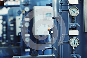 Closeup vertical image of barometers at industrial plant