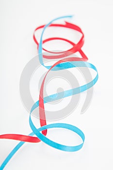 Closeup of vertical interweaving red and blue wavy ribbons
