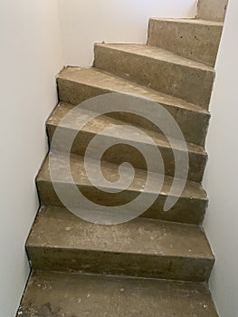 Closeup vertical shot of a concrete spiral staircase during the home renovation process