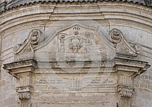 Closeup view of the architrave above the front door of the Church of Purgatory, Matera