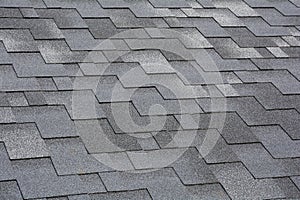 Closeup view on Asphalt Roofing Shingles Background. Roof Shingles - Roofing.