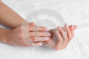 Closeup view of beautiful female hands on towel