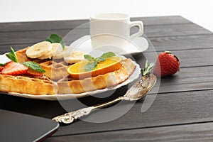 Closeup view of belgium waffles with different fruits and berries