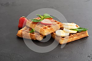Closeup view of belgium waffles with different fruits and berries