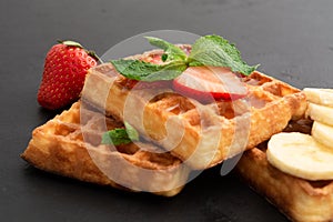 Closeup view of belgium waffles with different fruits and berries