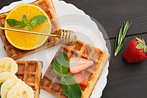 Closeup view of belgium waffles with different fruits and berries