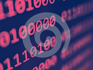 Closeup view of binary computer code with pink 1s and 0s displayed on a blue screen with focus blur effect
