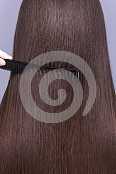 A closeup view of a bunch of shiny straight brown hair