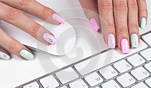 Closeup view of a business woman hands typing on wireless computer keyboard on office table. Soft lightning