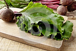 Closeup view of chard,leaves and beetroots on soup on cutting board