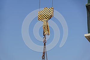 Closeup view of crane hook against blue sky