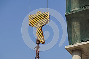 Closeup view of crane hook against blue sky