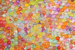 Closeup view of different color vase fillers as background. Water beads