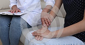 Closeup view doctor holding and stroking female patient hands