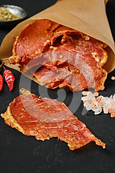 Closeup view of dried pork jerky in parchment