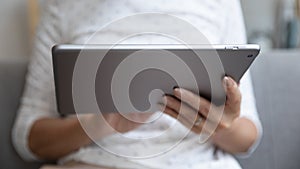 Closeup view female hands holding digital electronic device tablet computer