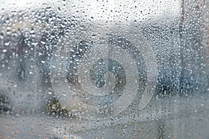 Closeup view of foggy window with rain drops