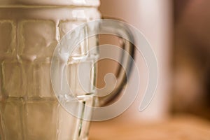 Closeup view fresh kefir probiotik drink emerged from overfilled empty glass on kitchen table