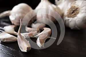 Closeup view of garlic`s & cloves on wooden board