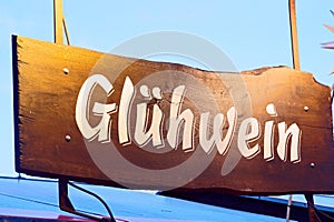 Closeup view of the Gluhwein sign on a wooden board