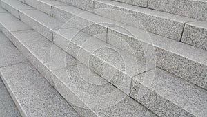 Closeup view of grey concrete stairs with dark concrete lines on footsteps