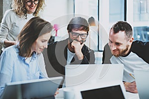 Closeup view of group of young coworkers brainstorming process at sunny office.Blurred background.