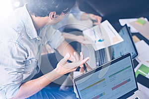 Closeup view of Group of young coworkers working together in modern office studio.Businessman talking with partners