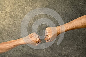 Closeup view of a hand giving a fist bump greeting for unity and teamwork