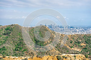 Closeup view of a hill on city buildings background