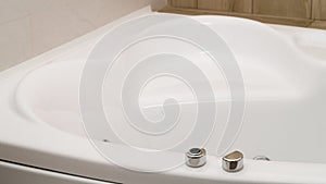 Closeup view of hot tub with buttons indoors