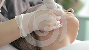 Closeup view of hydropeeling vacuum at the neck area of young woman in spa slow motion