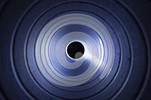 Closeup view from inside the galvanized steel air duct on the exhaust fan in the background light, the front and back background