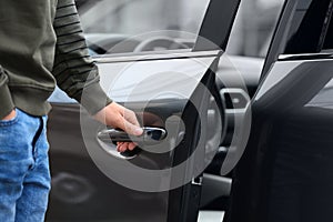 Closeup view of man opening car