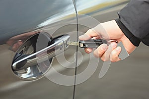 Closeup view of man opening car door