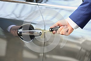 Closeup view of man opening car door