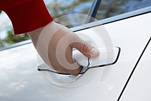 Closeup view of man opening car door outdoors