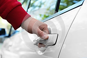 Closeup view of man opening car door outdoors