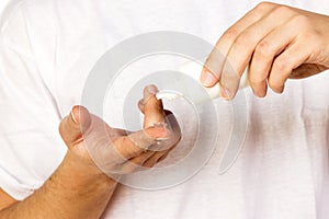 Closeup view of a man's cleaning corrective contact lens on a fi