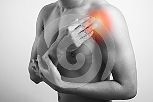 Closeup view of man showing his front shoulder pain photo