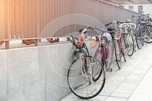 Closeup view many city bikes parked in row at european city street rental parking sharing station or sale. Healthy