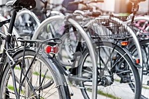 Closeup view many red city bikes parked in row at european city street rental parking sharing station or sale. Healthy